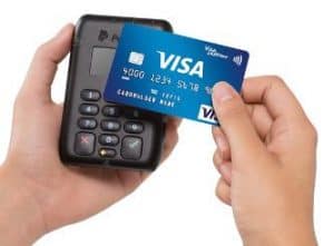 a person holding a credit card and a phone 