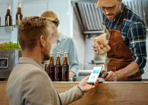 a person paying with a phone 