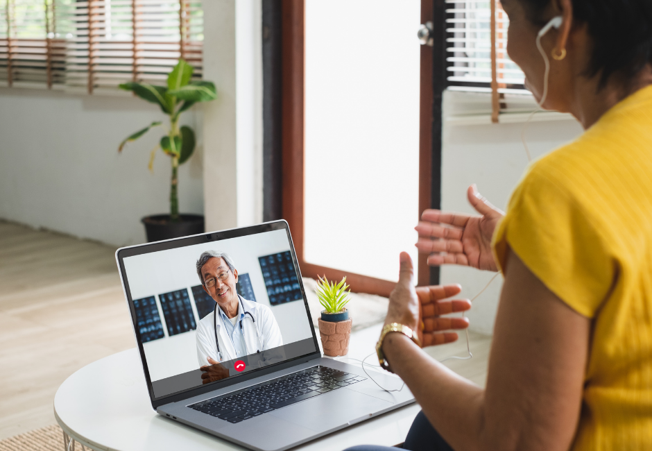 woman speaking to doctor on telehealth visit in living room