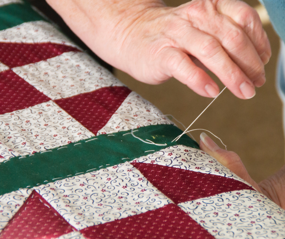 woman sewing a quilt